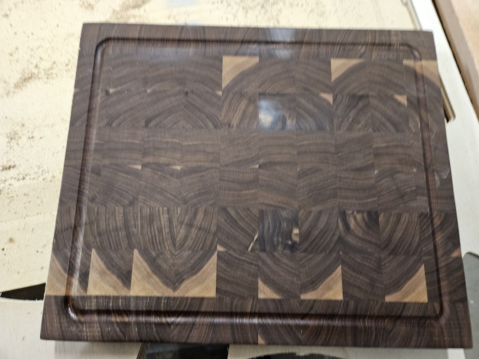 End-grain walnut cutting board with a juice groove